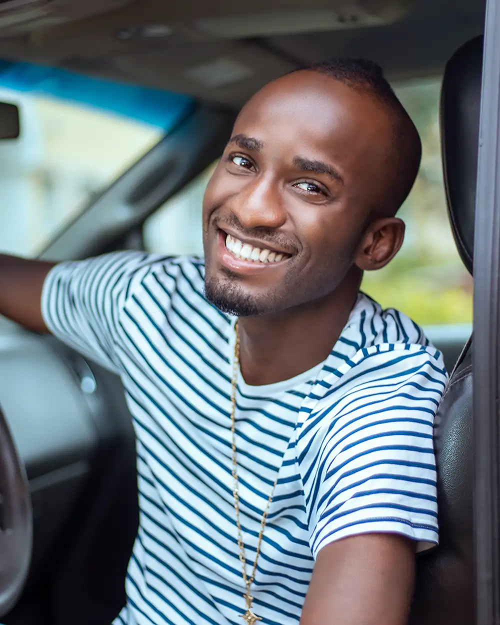 a guy smiling in the car