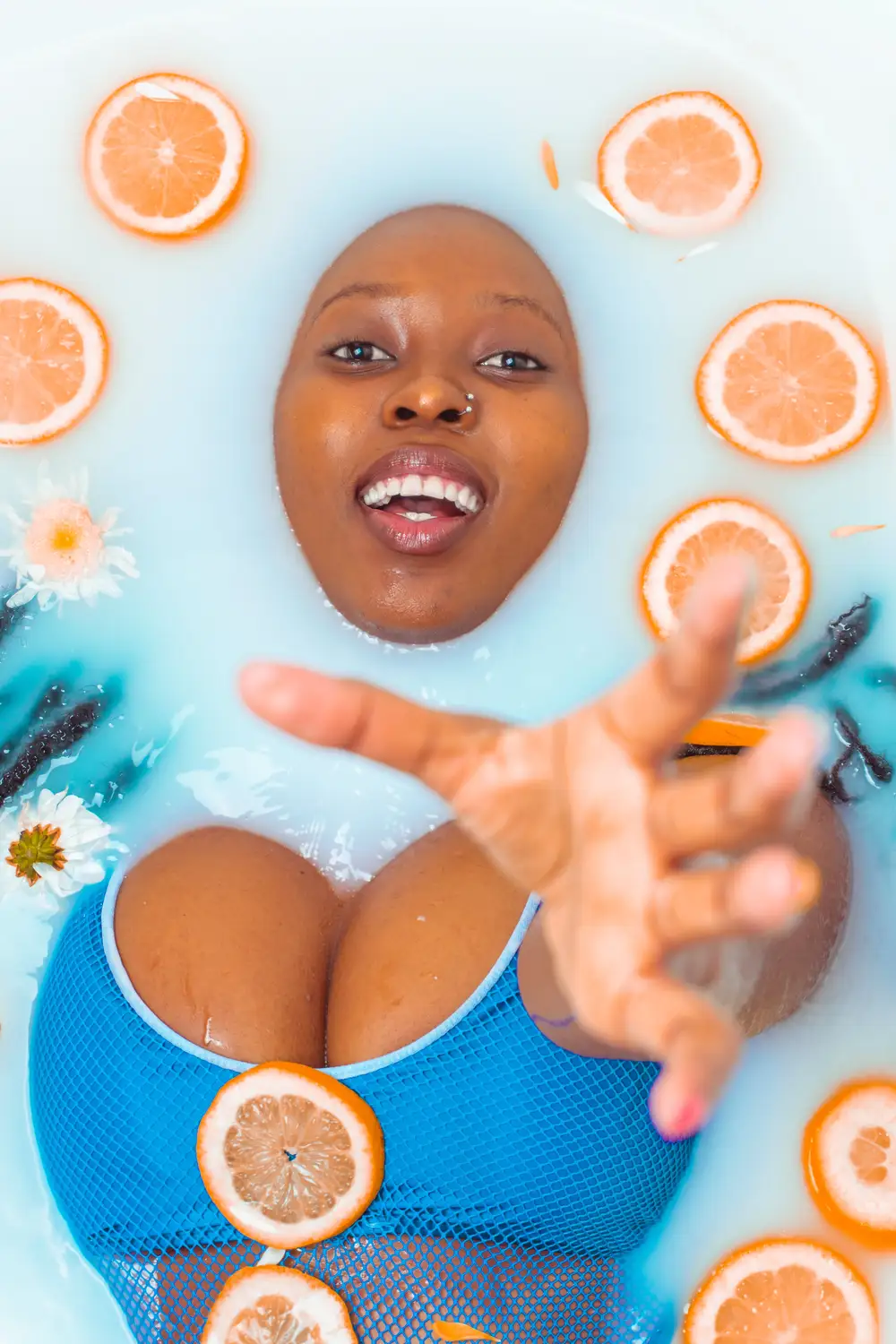 Girl in water decorated with orange slice