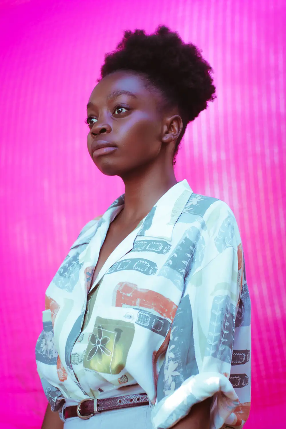 Black girl on afro behind pink background