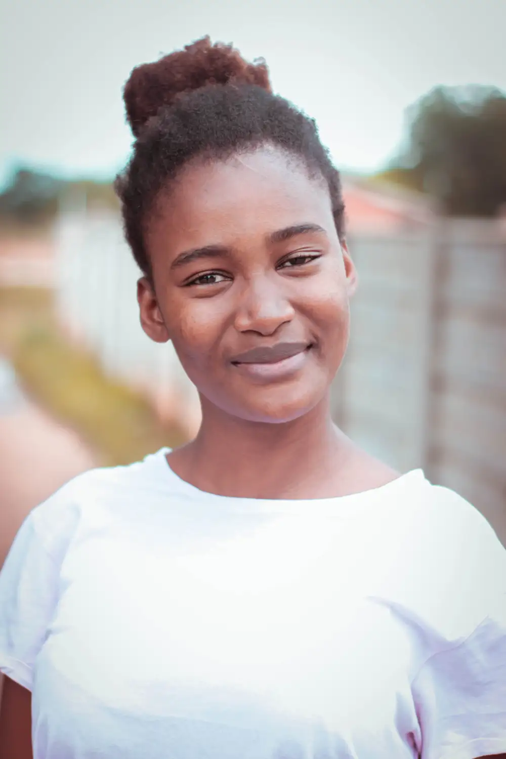 Black girl on white round neck smiling