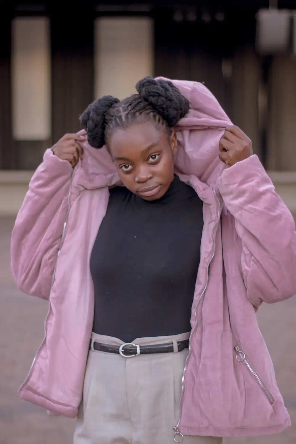 Girl on black turtle neck top and pink sweater