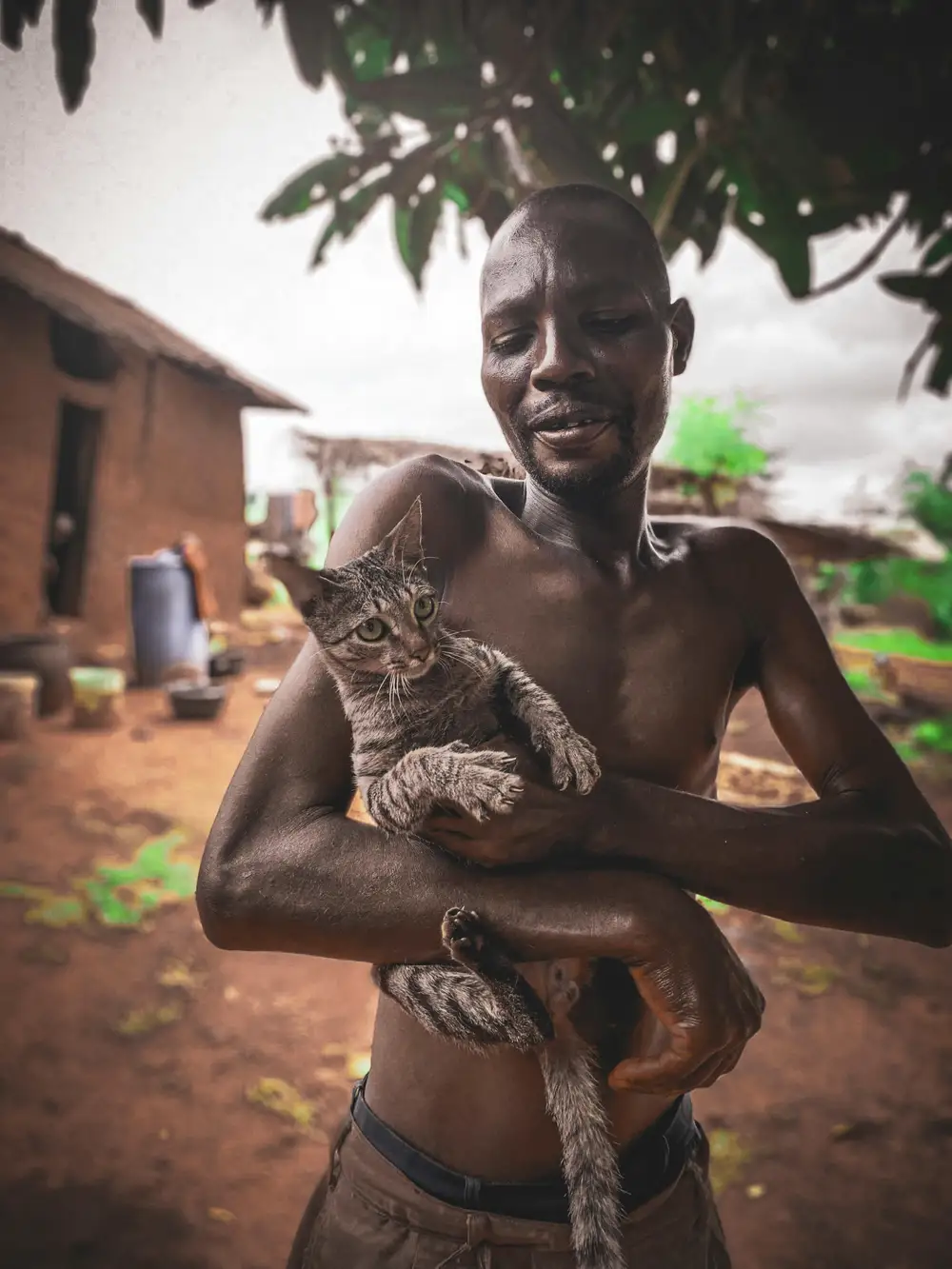 man carrying a cat