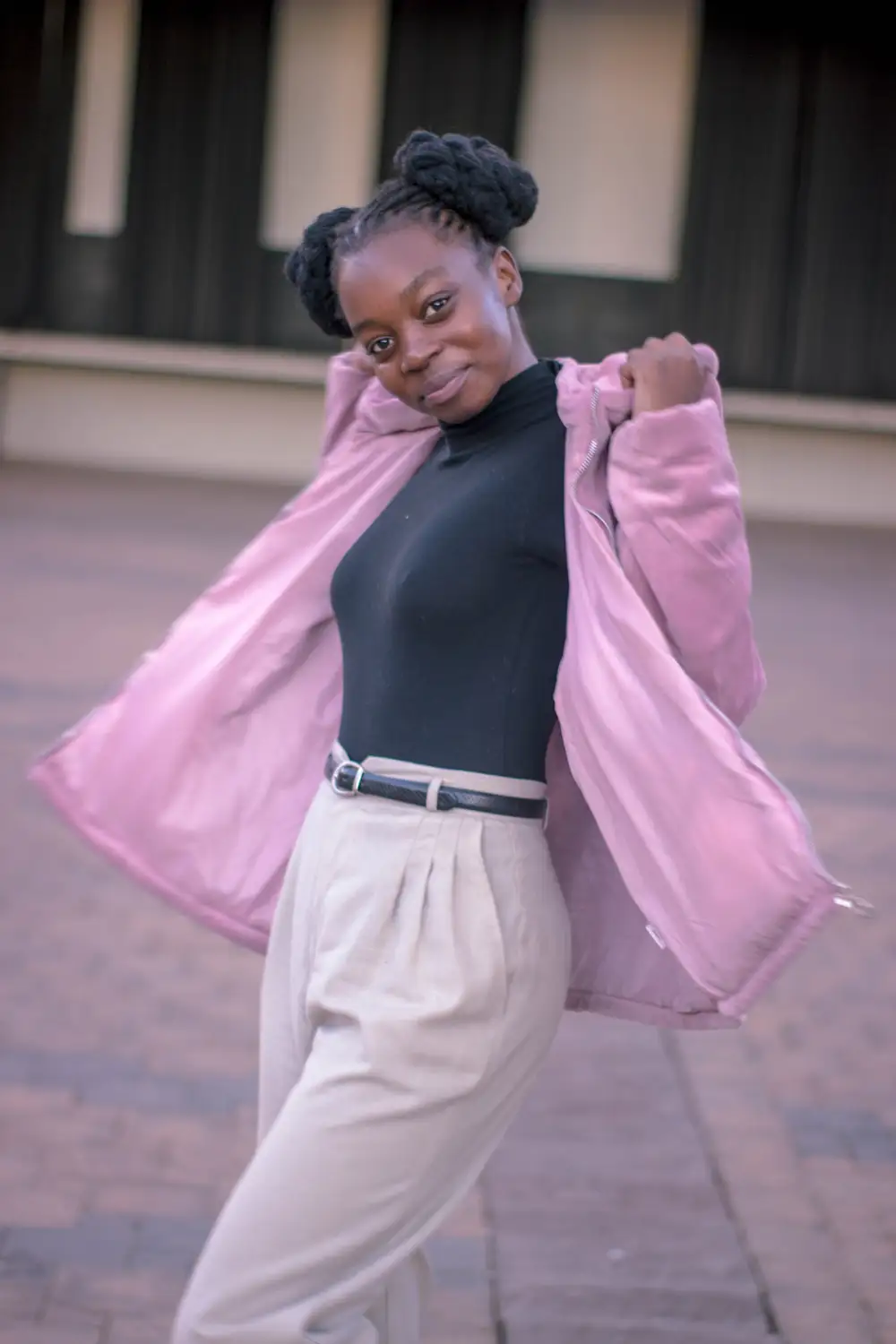 Black girl on turtle neck and pink jacket