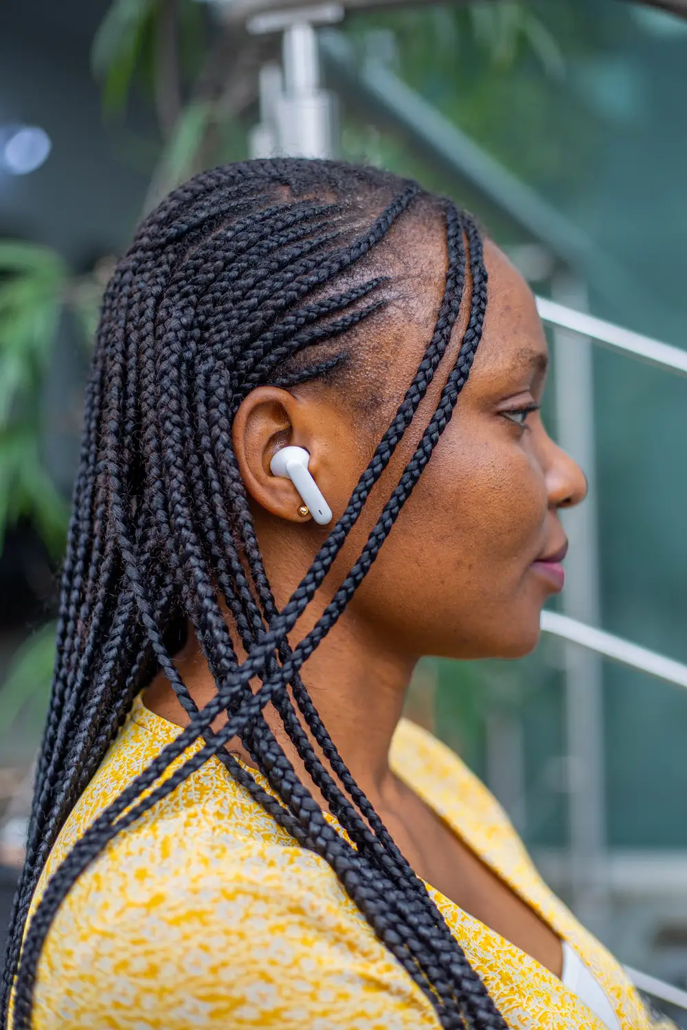 side view of a woman wearing airpods and looking ahead