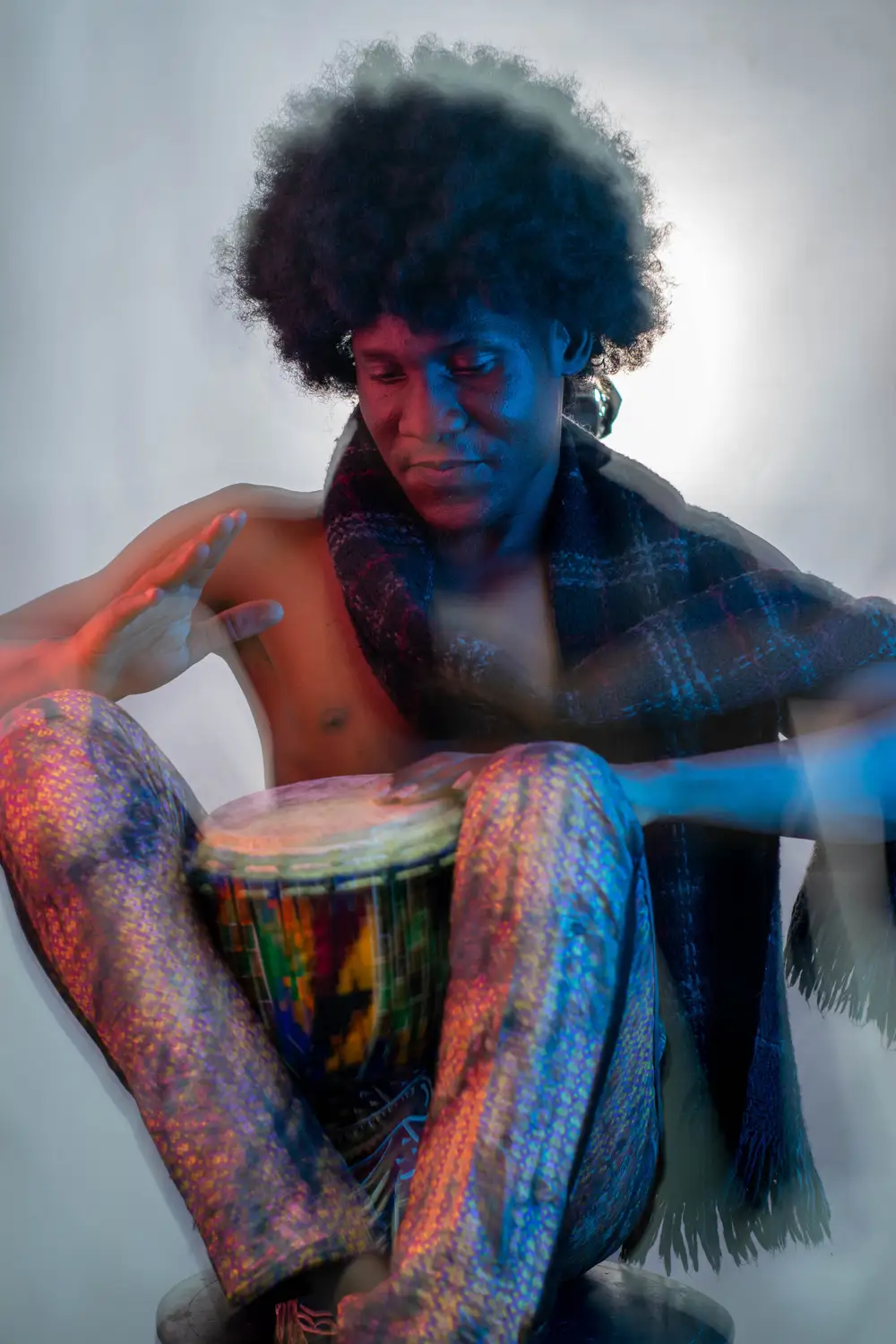 model on afro hairstyle playing his drum