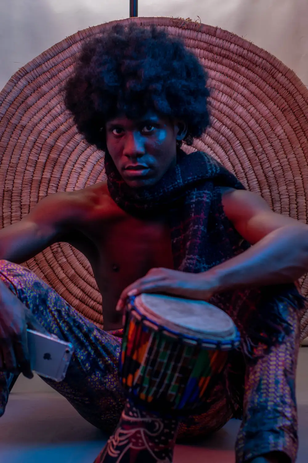 model on afro hairstyle plays his drum