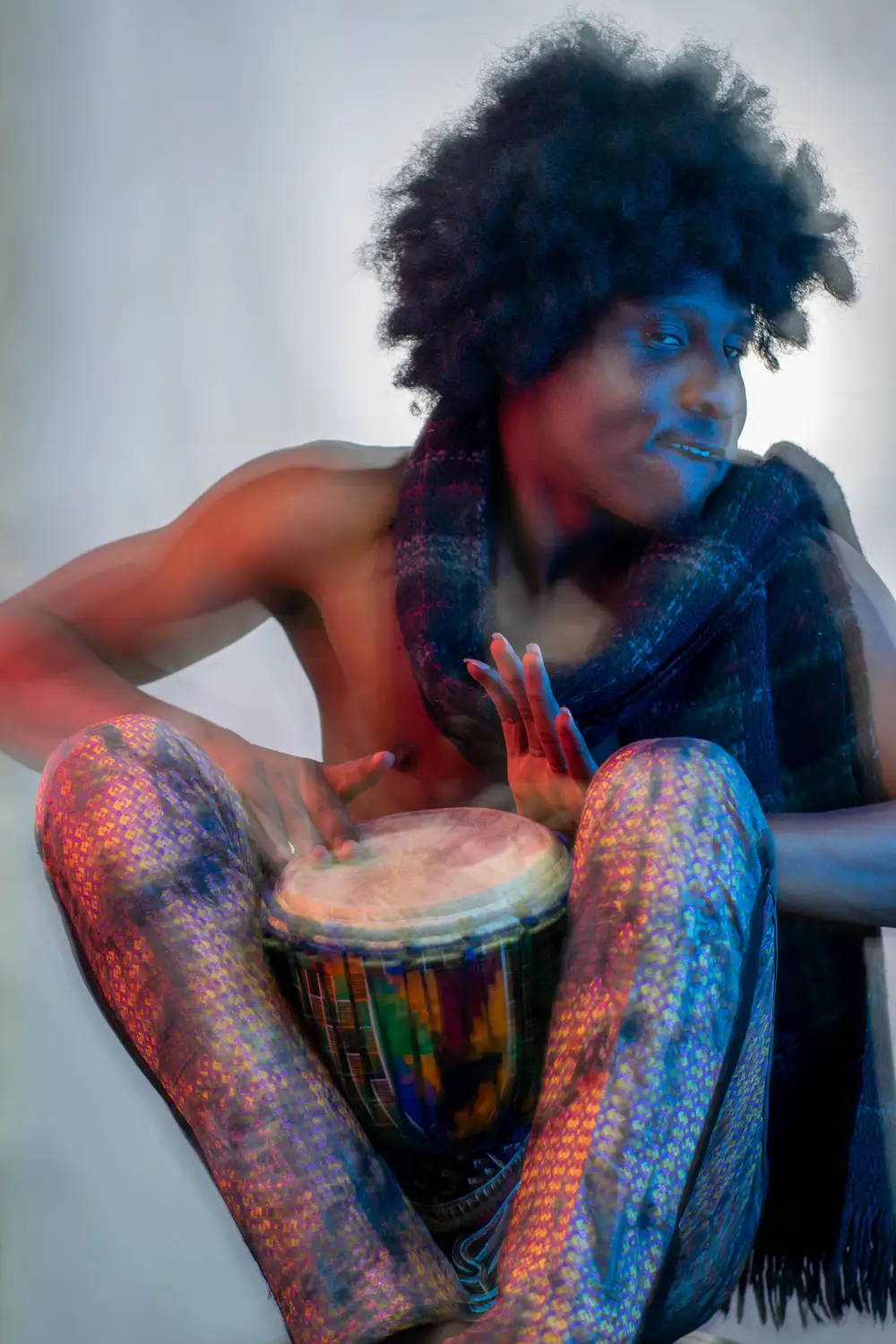 model on afro hairstyle plays drum 2