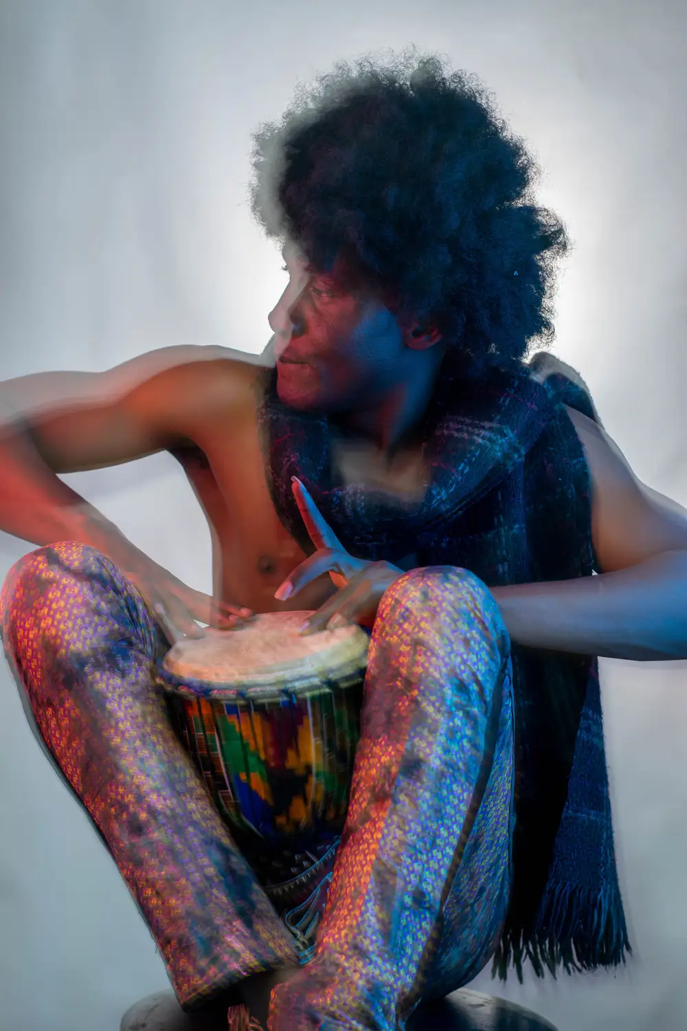 model on afro hairstyle plays drum 7