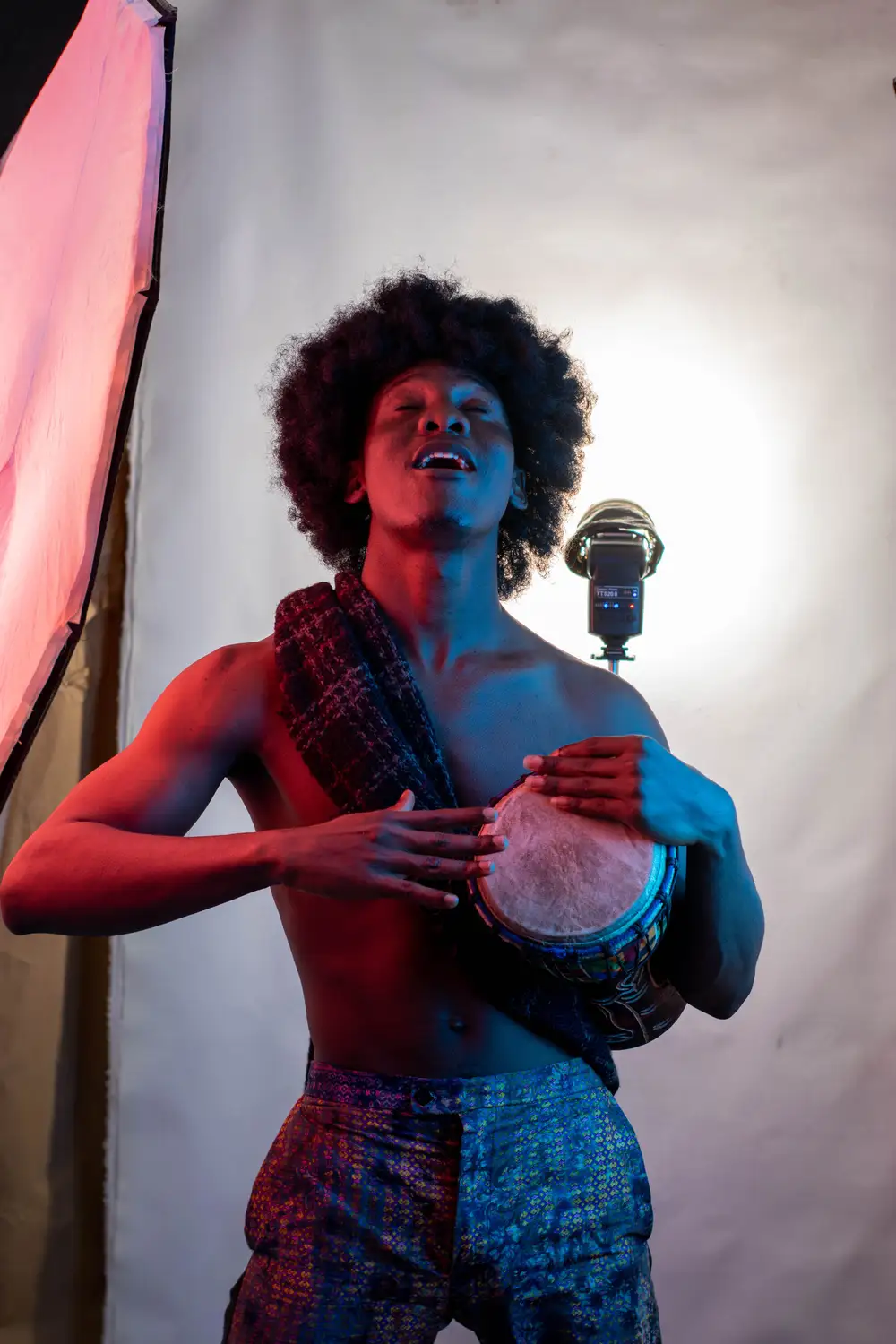 model on afro hairstyle plays drum 3
