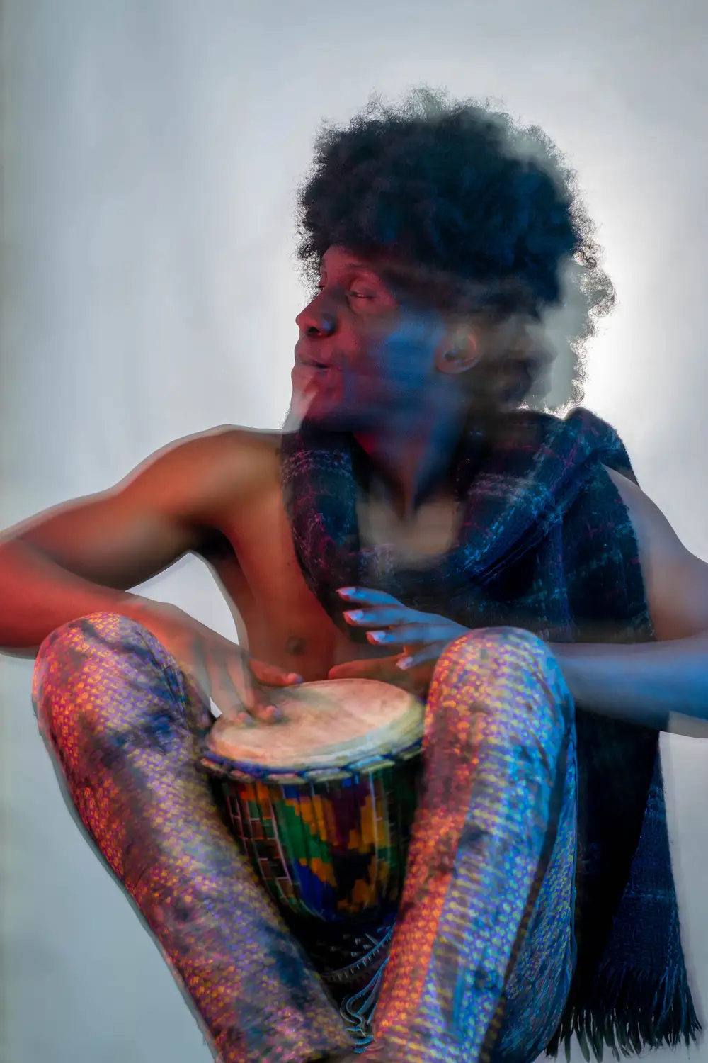 model on afro hairstyle plays drum 1