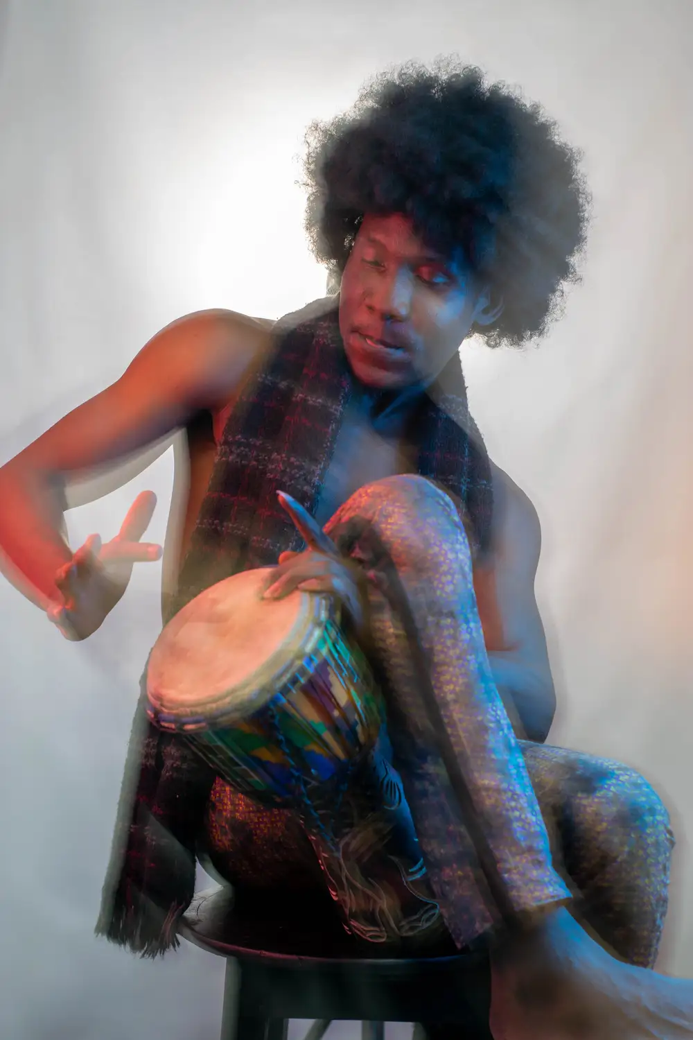 model on afro hairstyle plays drum 6