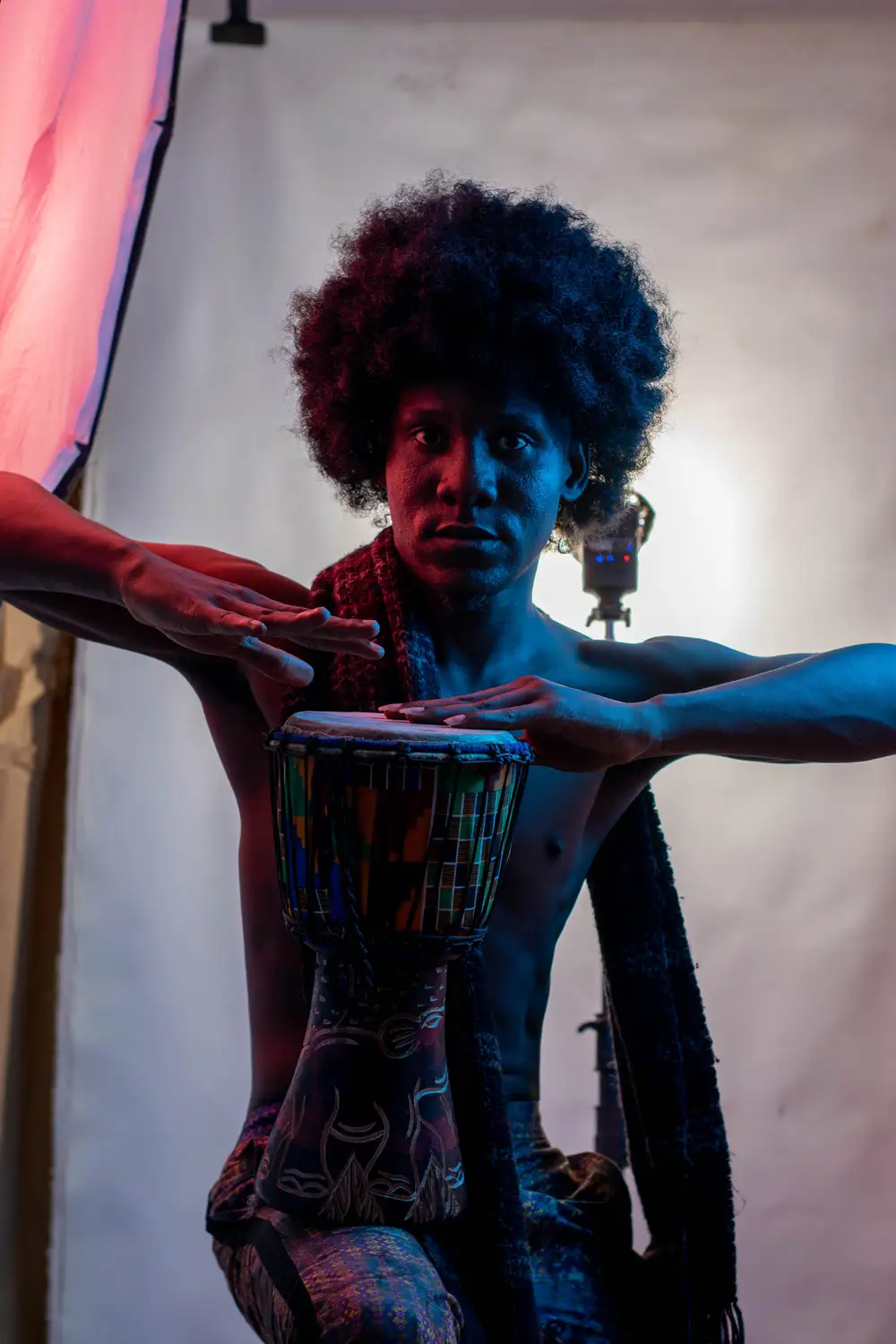 model on afro hairstyle plays drum 5