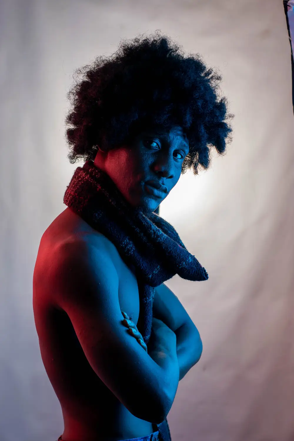 model on afro folds his hands