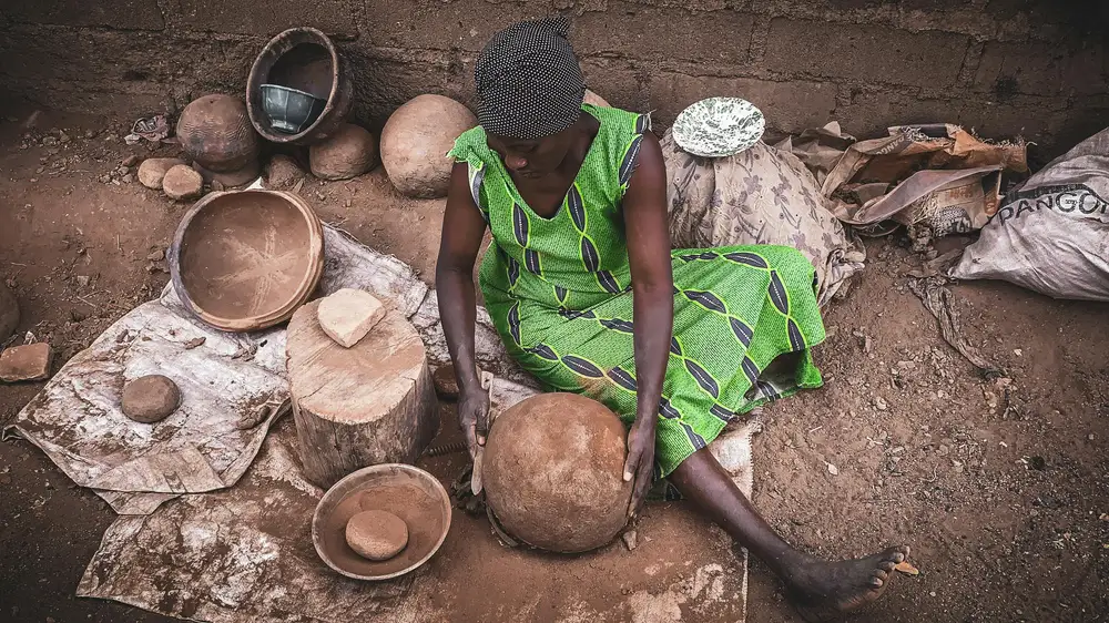woman molding a pot