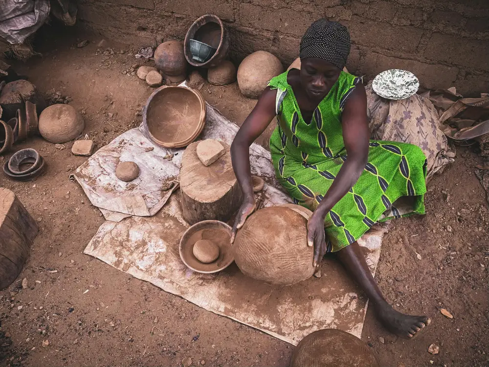 woman molding a pot