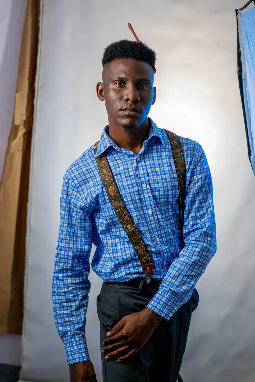 man in blue coloured shirt pose