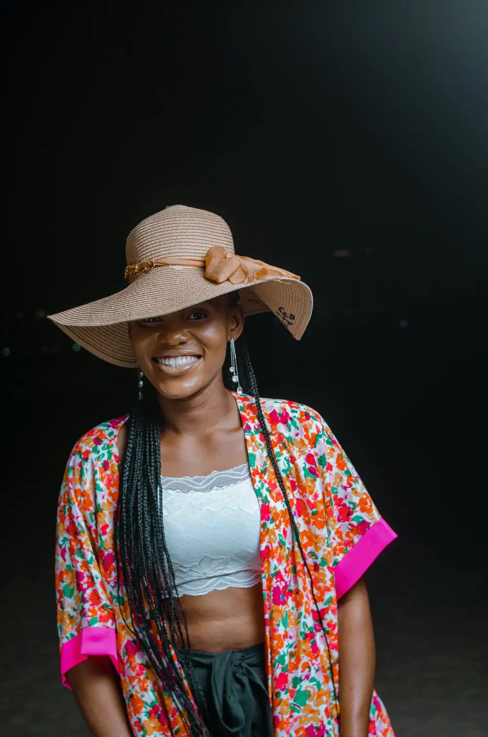 young lady in a hat smiling at the camera