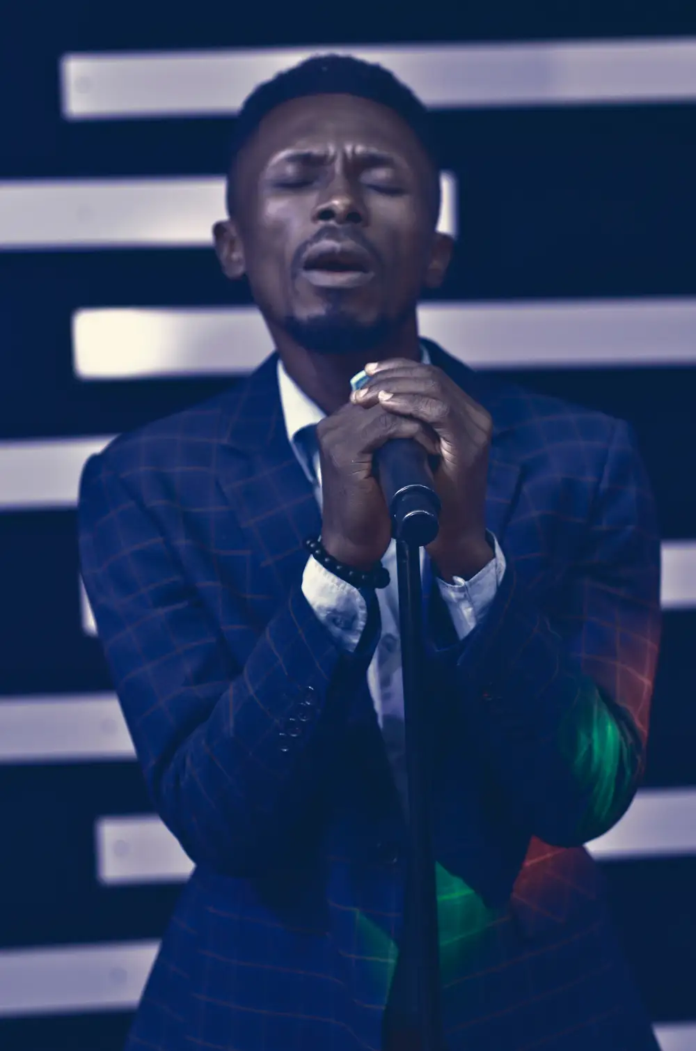 Man holding a microphone passionately