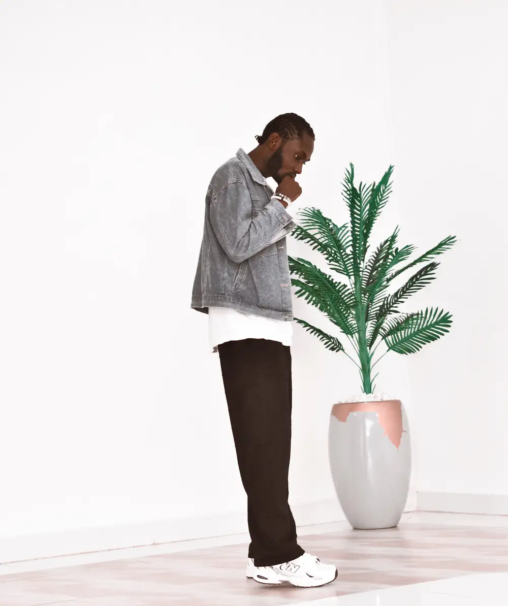 Guy standing by a flower vase