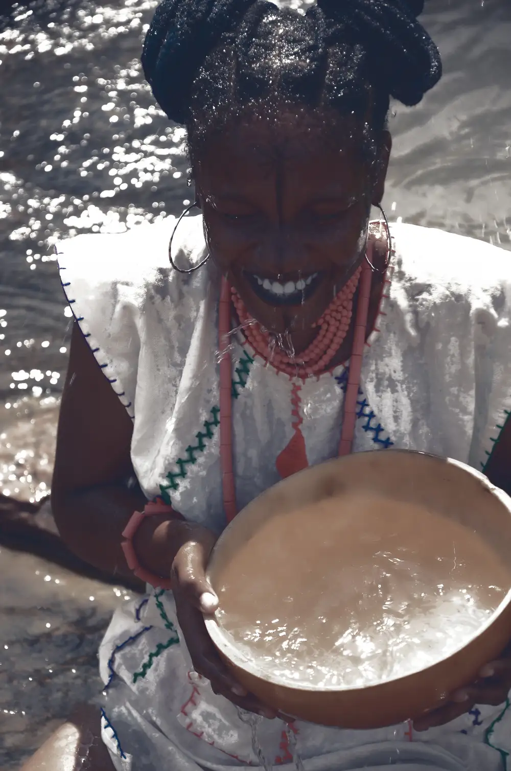 Girl smiling while holding a calabash