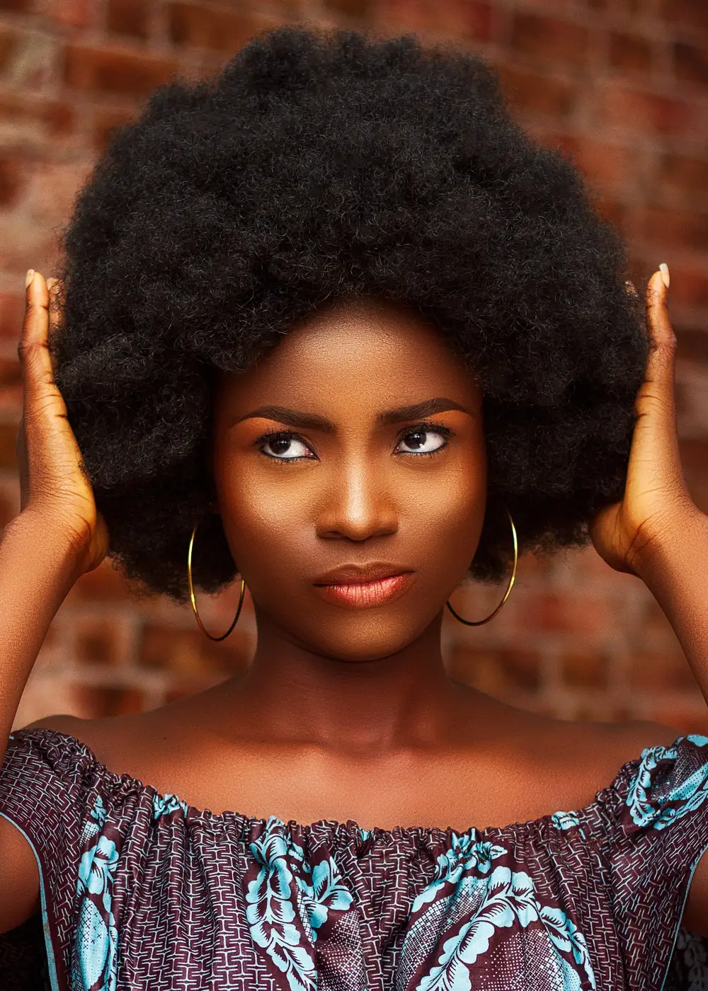 Lady holding her afro