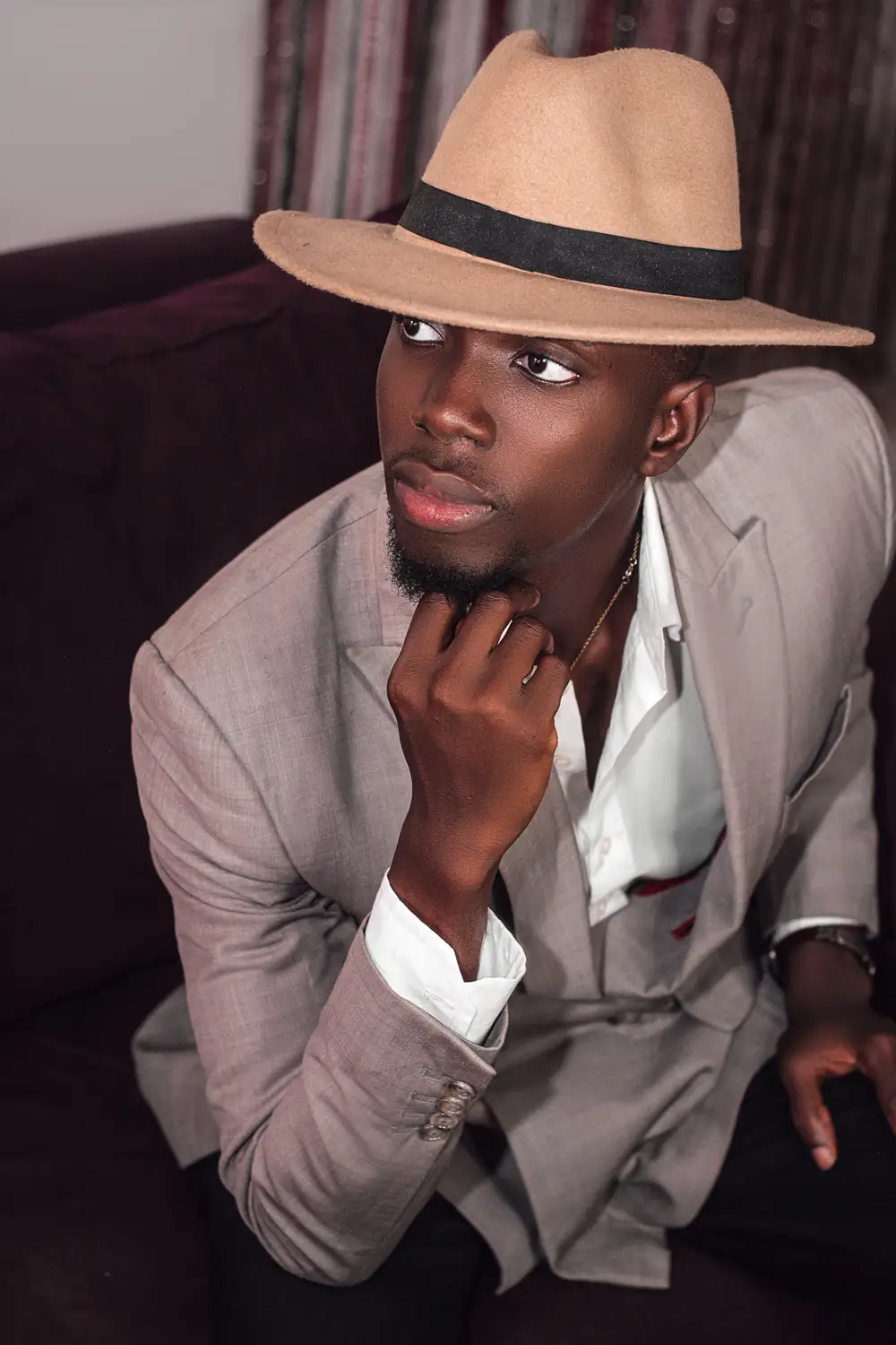 Young man in suit, wearing a hat
