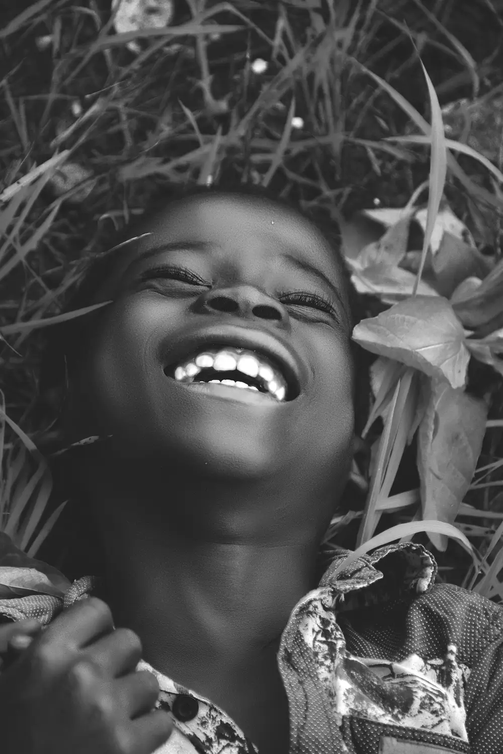 black and white portrait of a happy boy laughing
