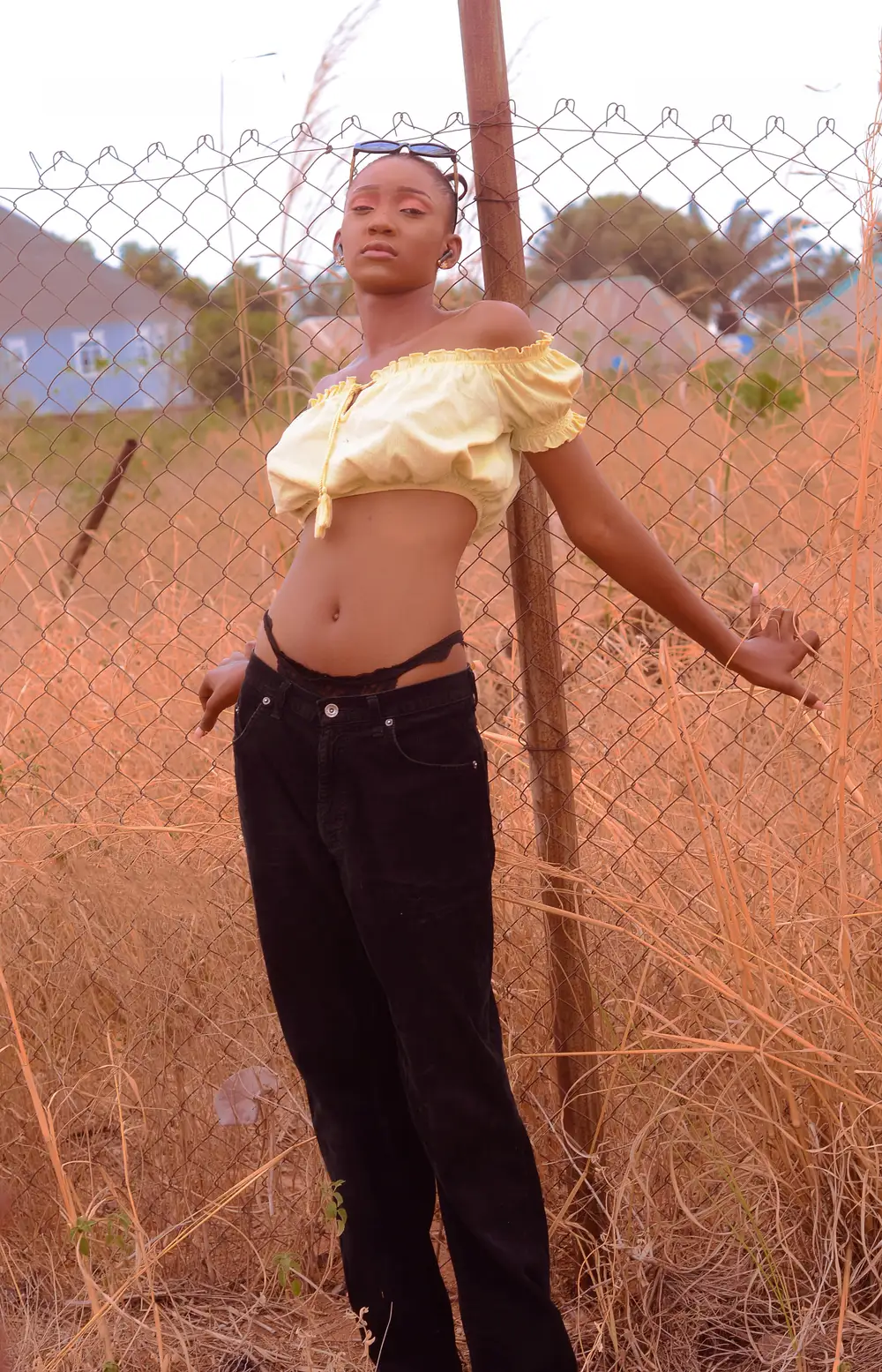 Girl with g string holding a net fence