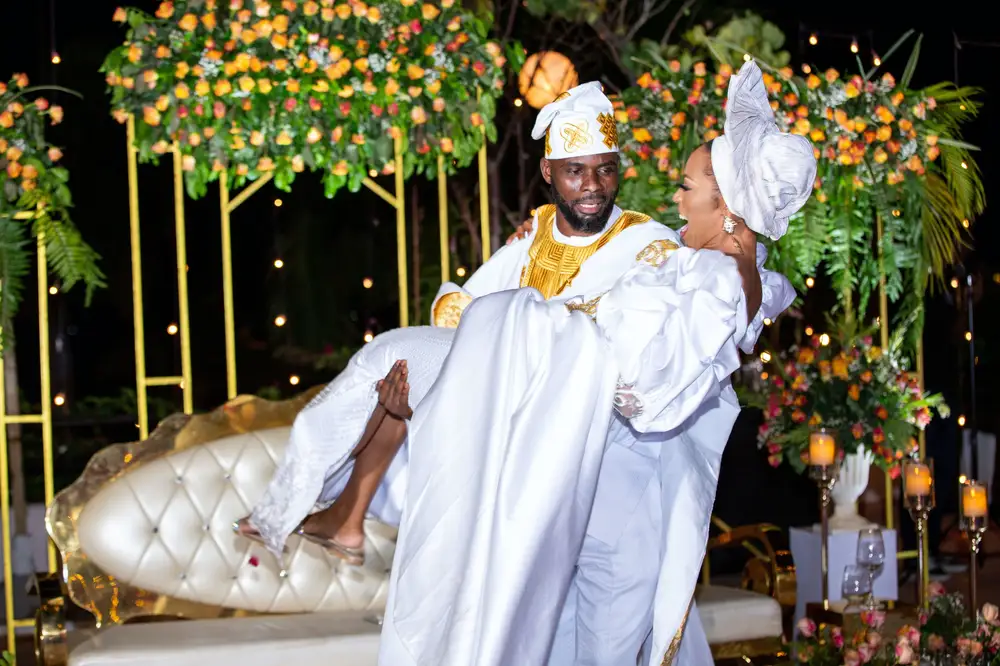 groom carrying bride