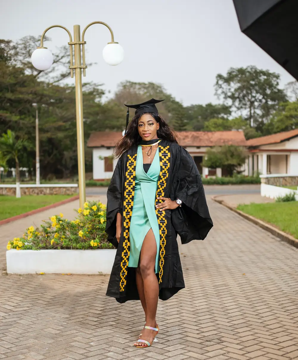 woman posing in graduation gown
