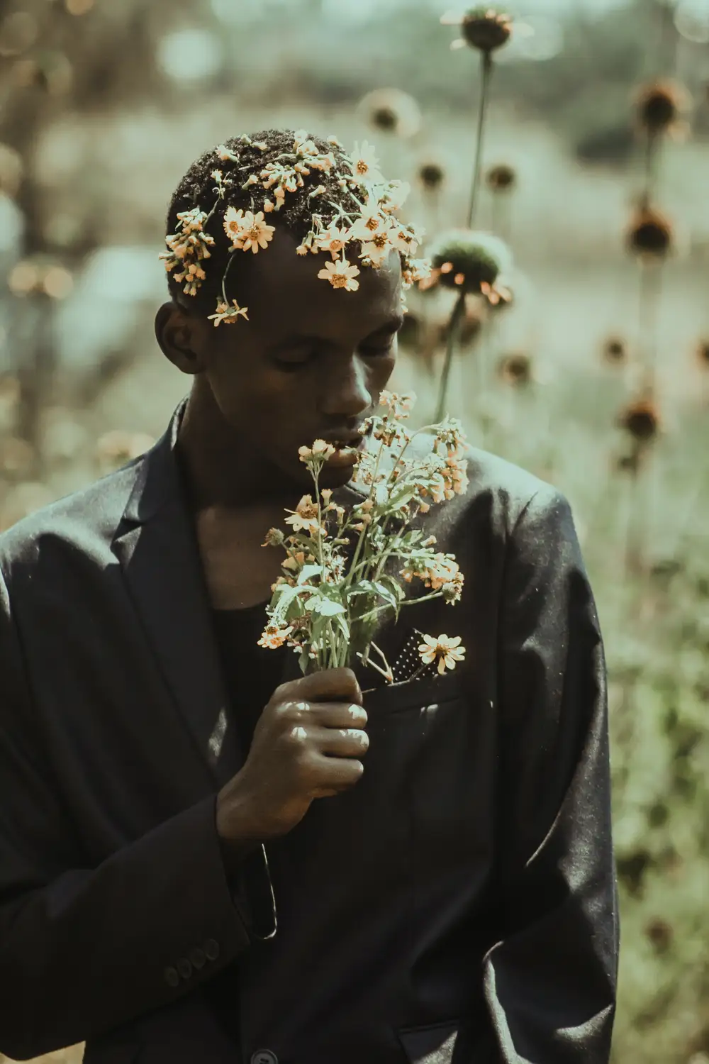 Guy smelling some flowers