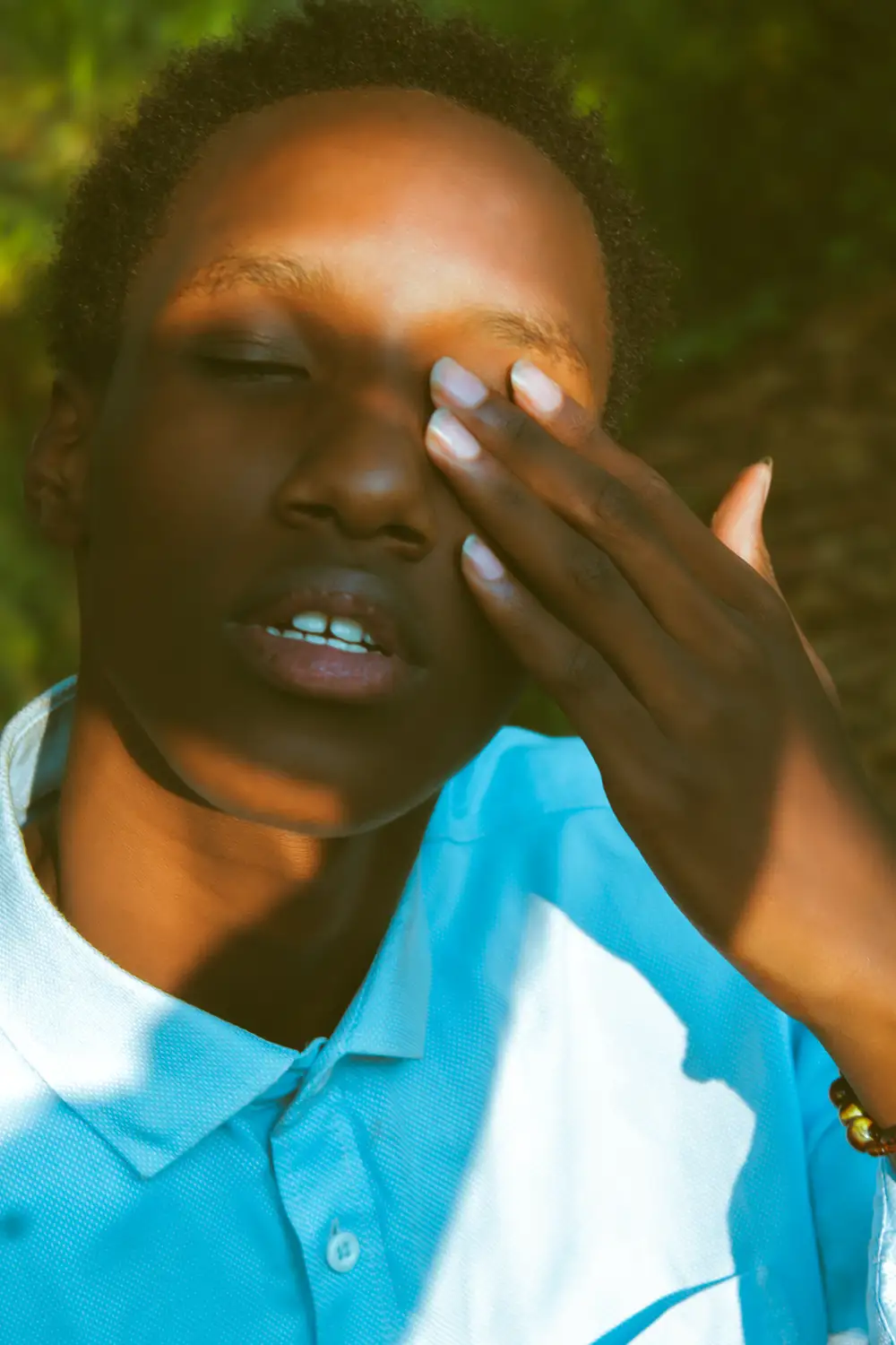 Boy protecting eyes from sun