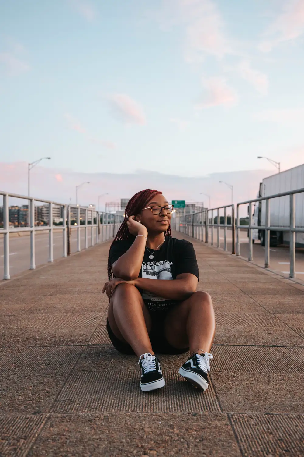 Young lady sitting on the road