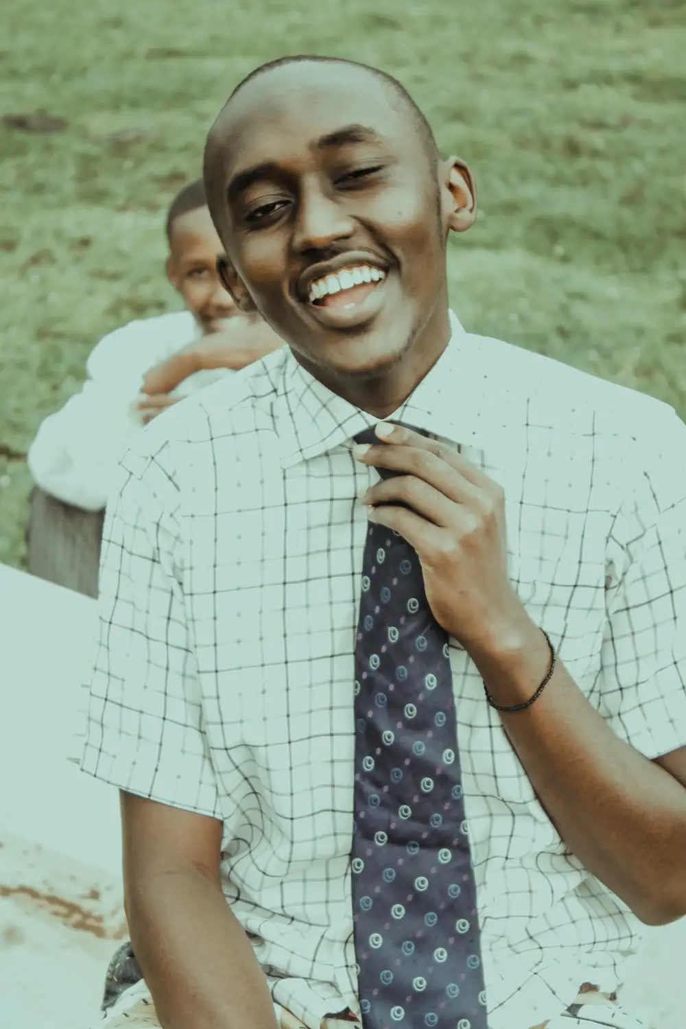 Smiling man on tie with friend