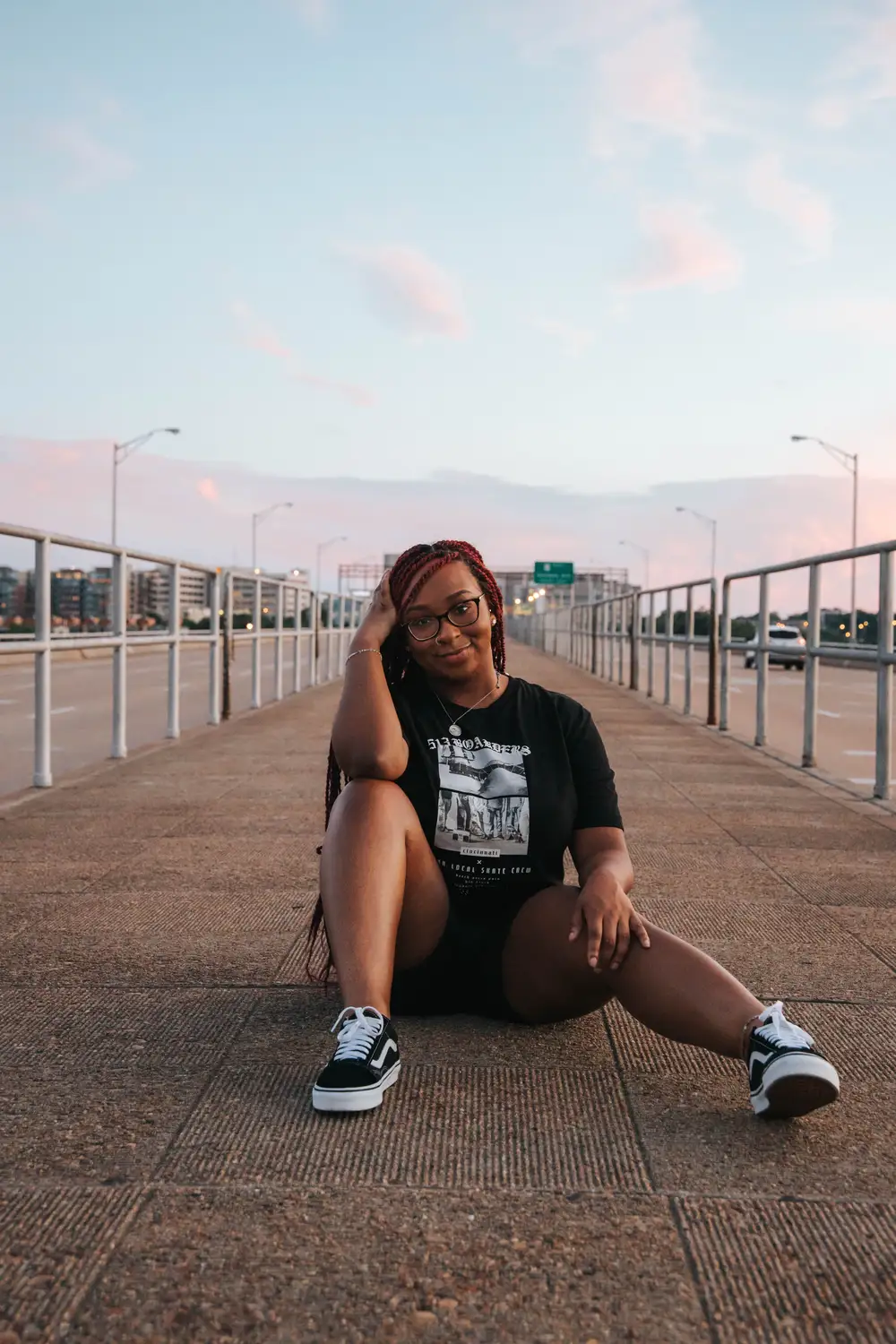 Young lady wearing a black shirt sitting on the floor