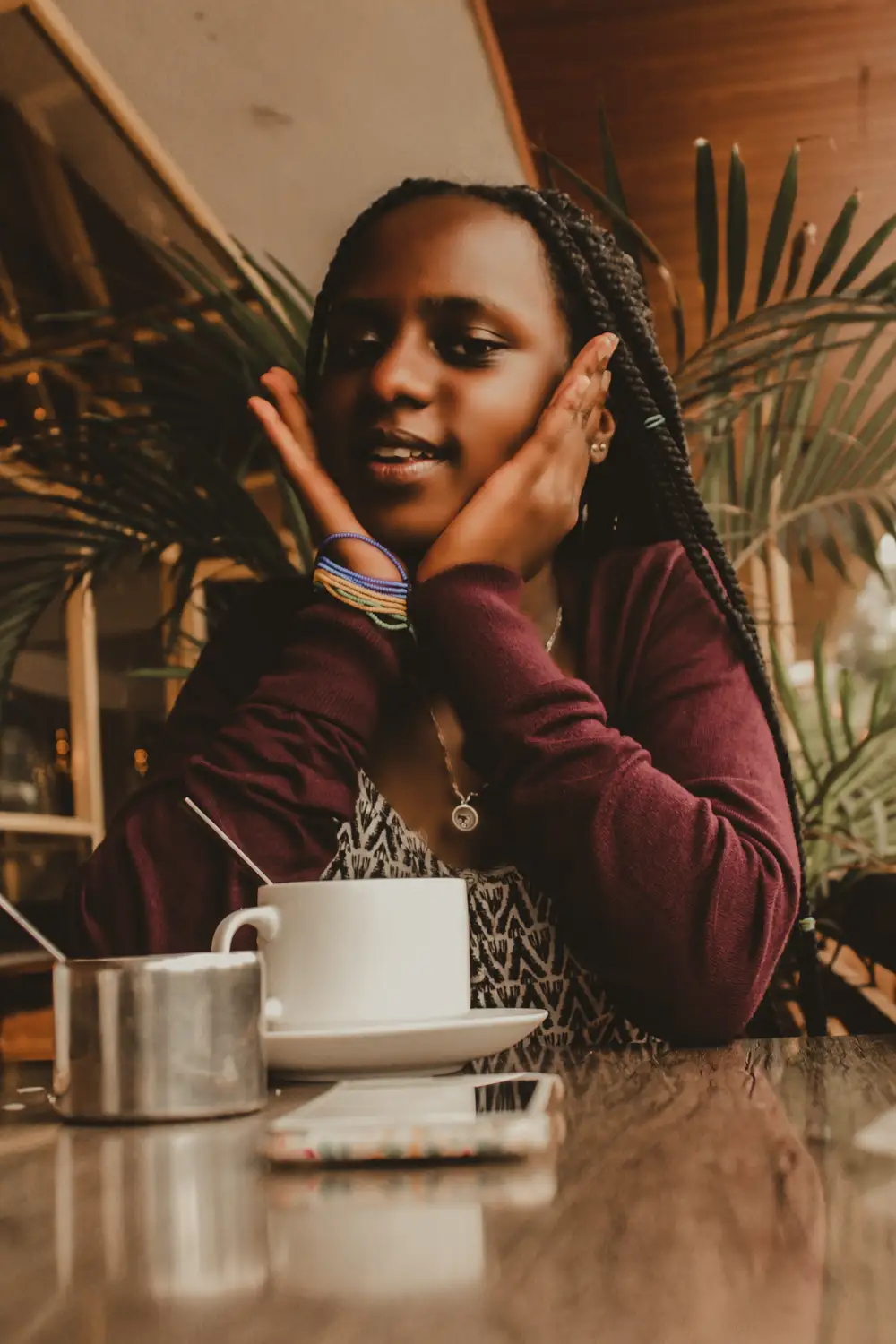 Lady at cafe with hands on her face