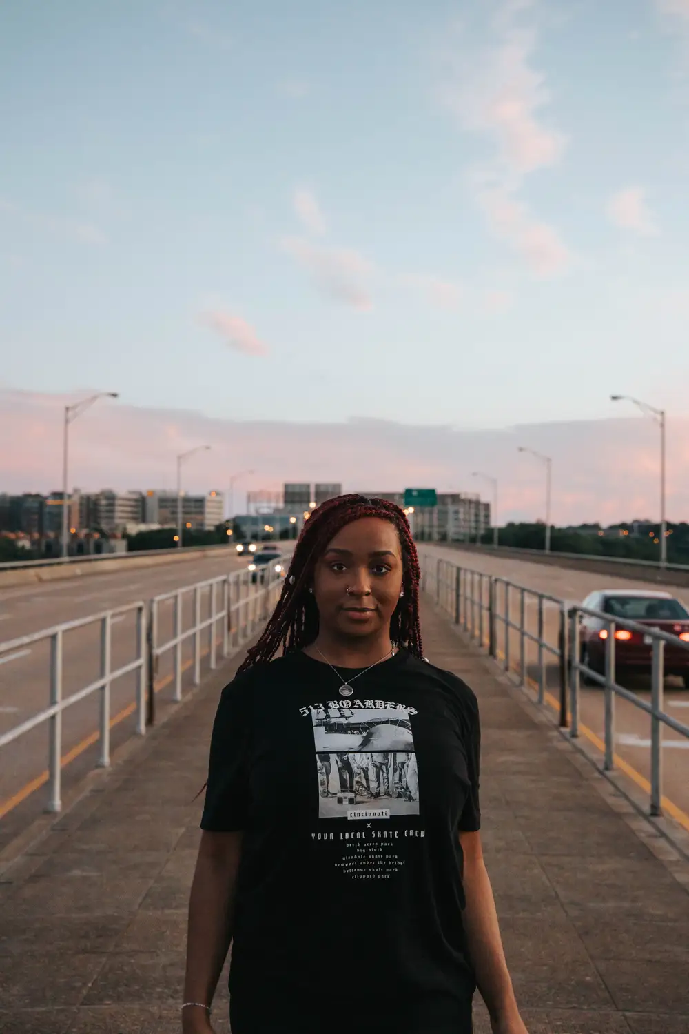 Young woman wearing a black shirt on the road