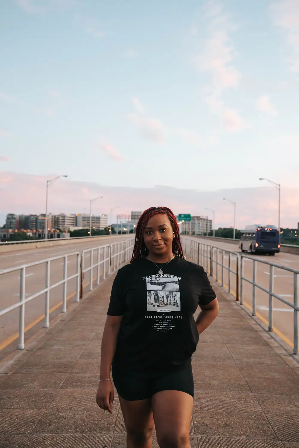 Smiling young woman along the road