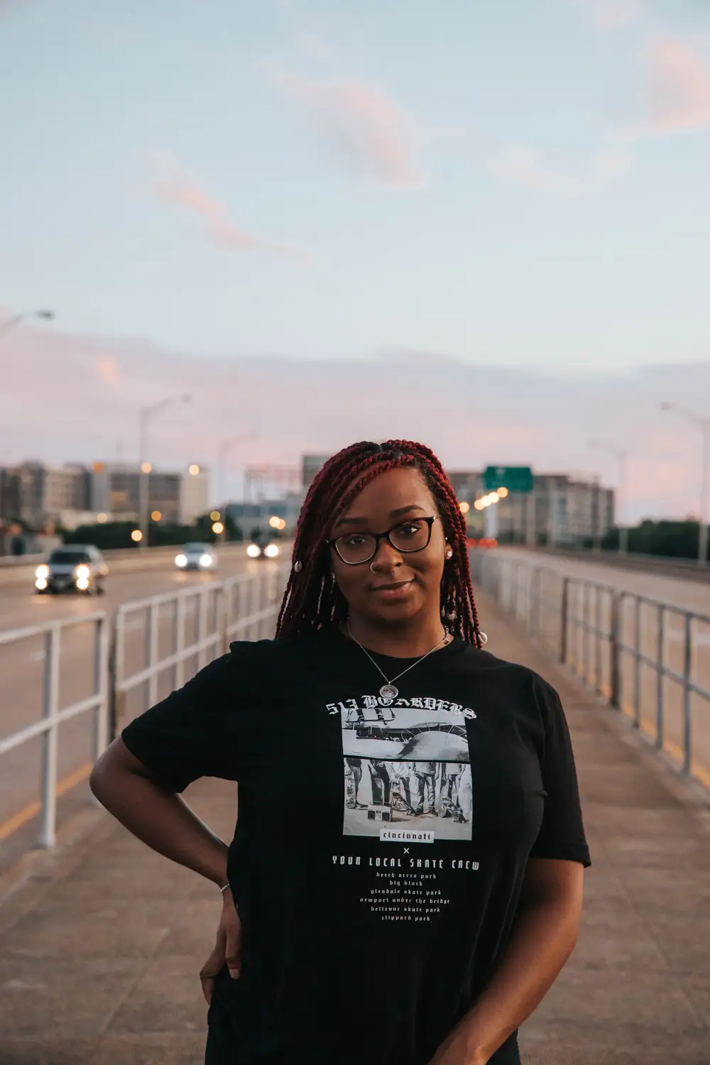 Black woman on glasses wearing a black shirt