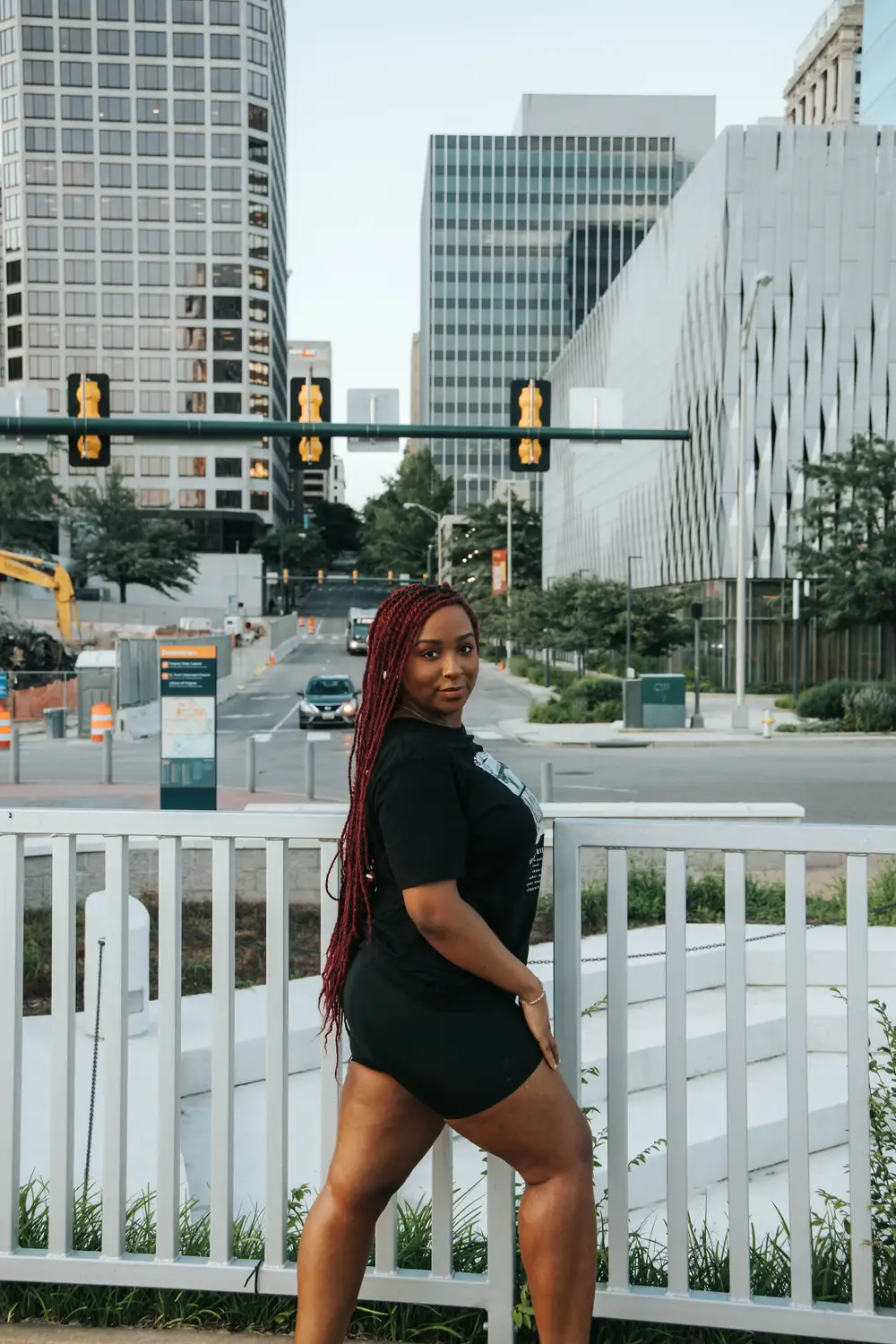 Young woman posing for picture by the railings