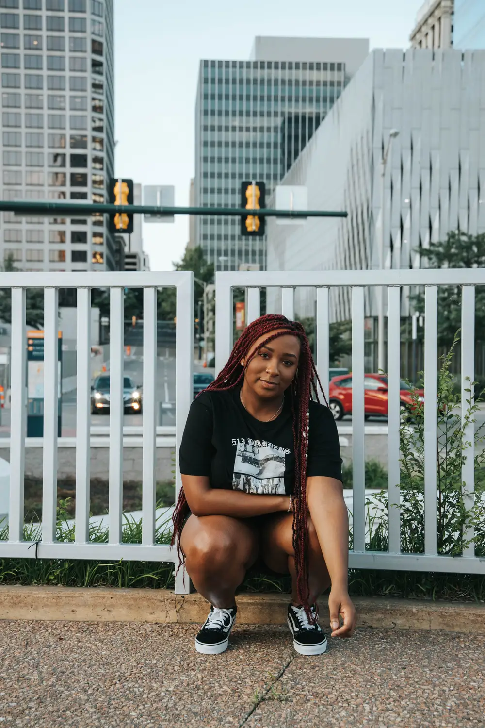 Young black woman squatting by the railings