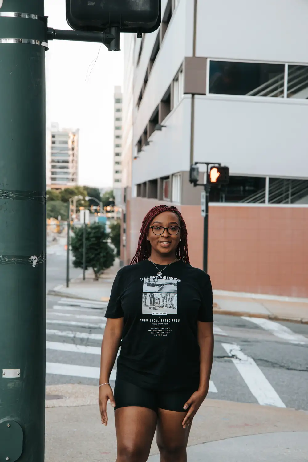 Young lady on braid near a traffic light