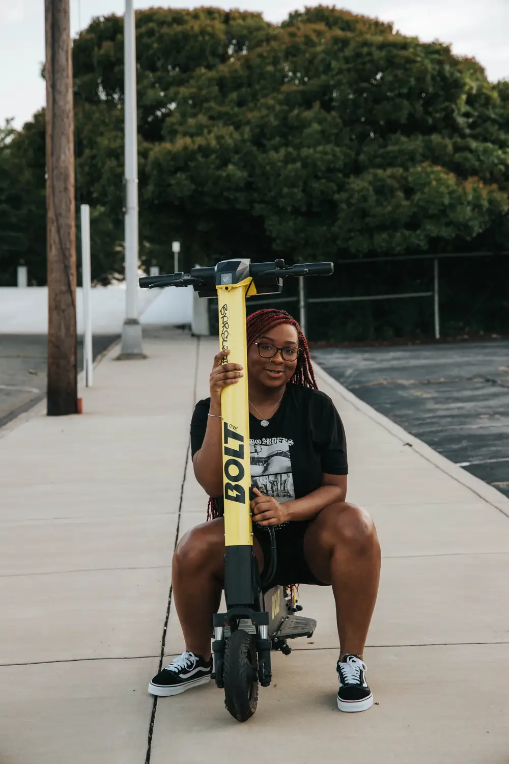 young lady sitting on a scooter