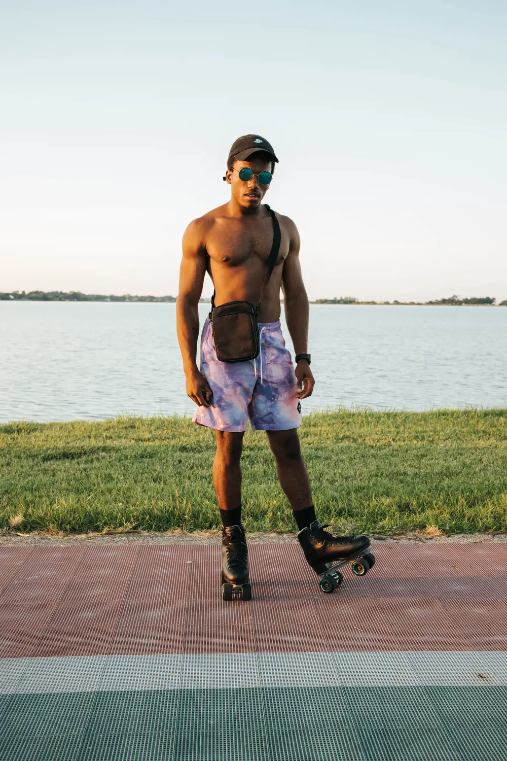 Young shirtless black man wearing a rollerskating shoe