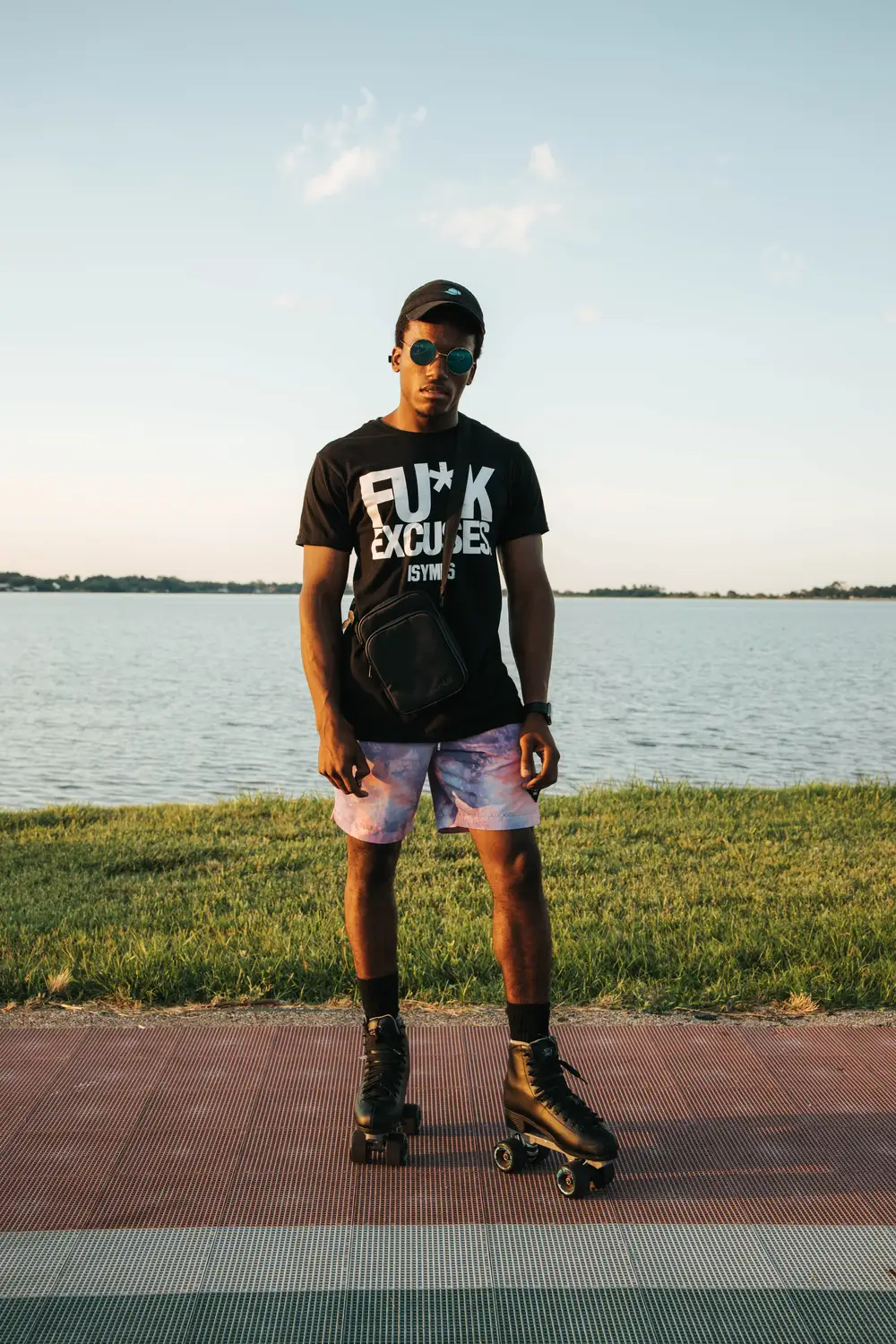 Black man wearing a black shirt on a short with a rollerskater