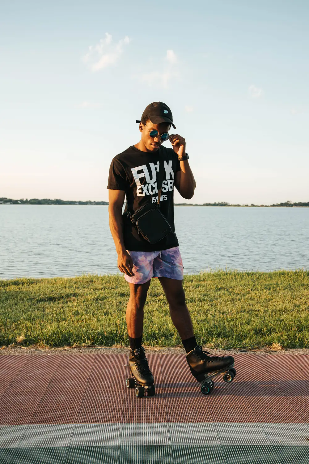 Young African with a rollerskating shoe by the river