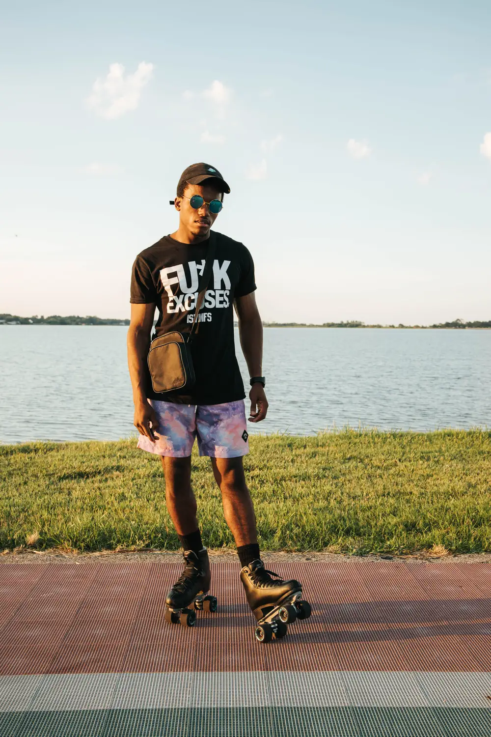 Young African wearing a rollerskating shoe by the river