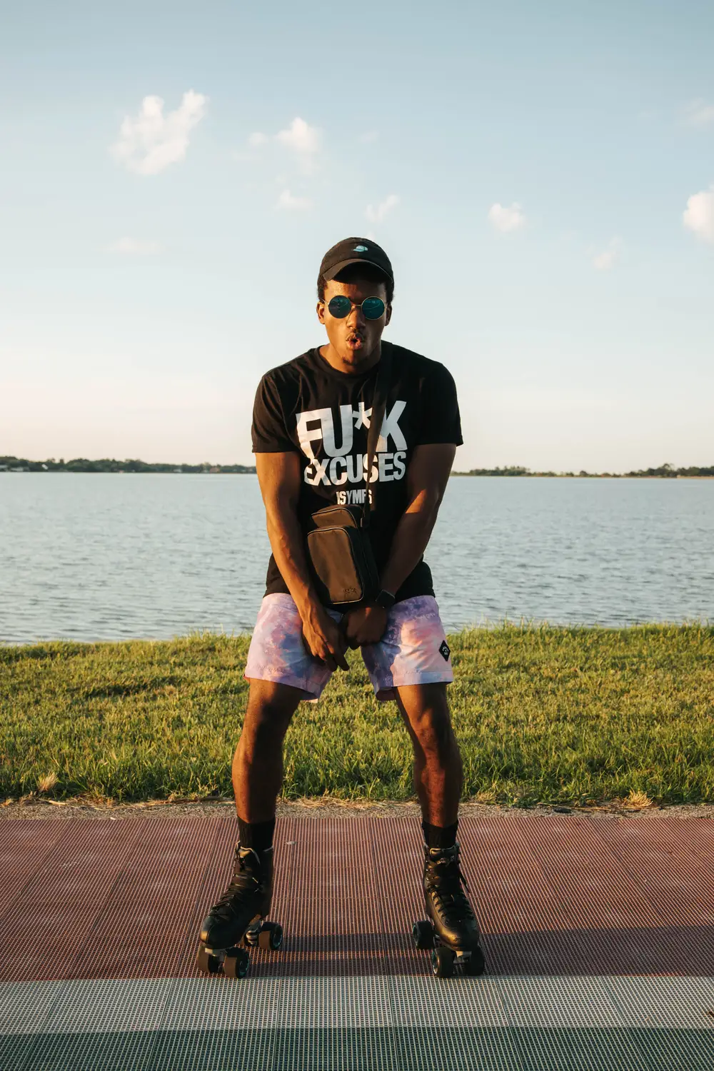 A young man posing for the camera by the river