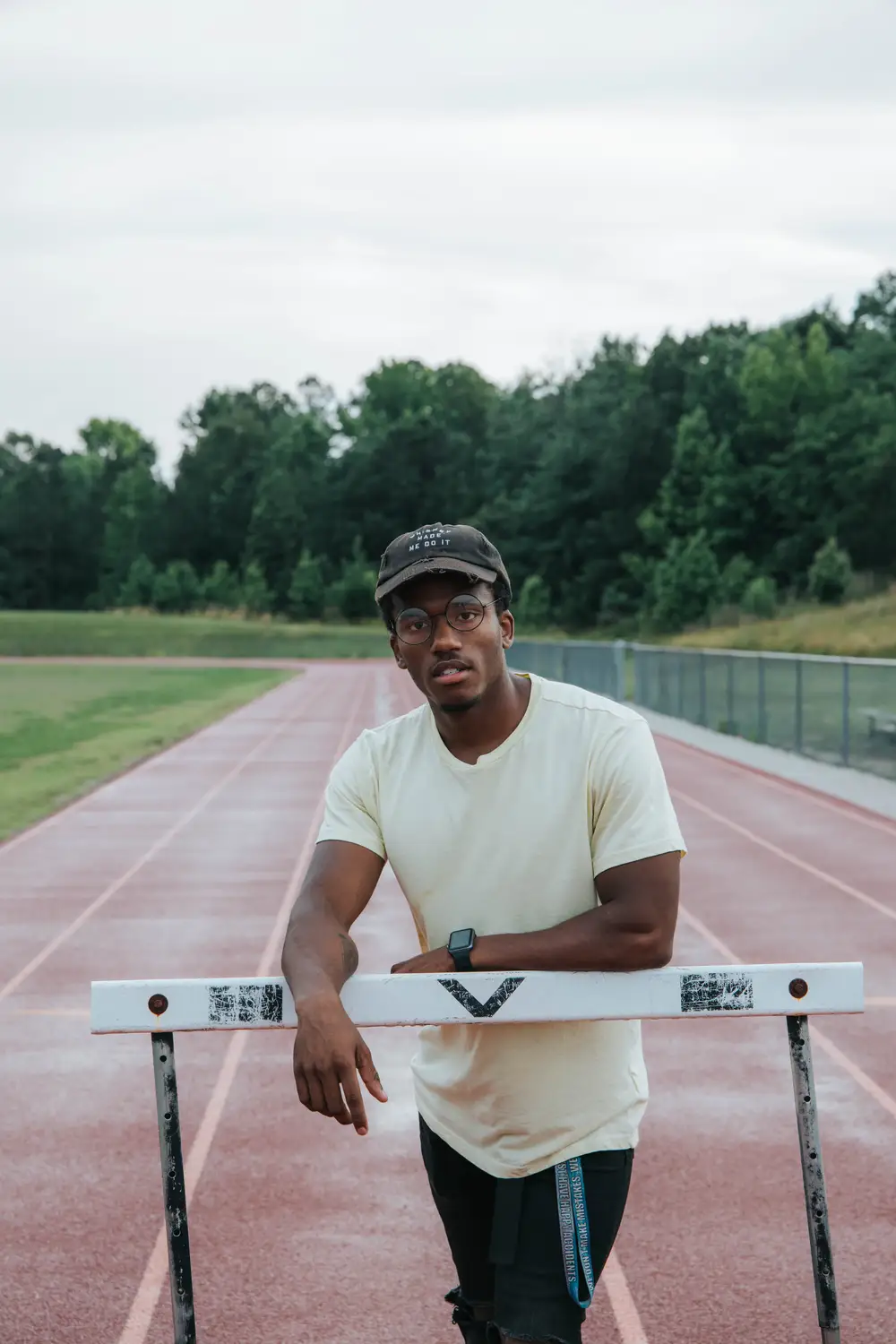 Young man on a track with a hurdle