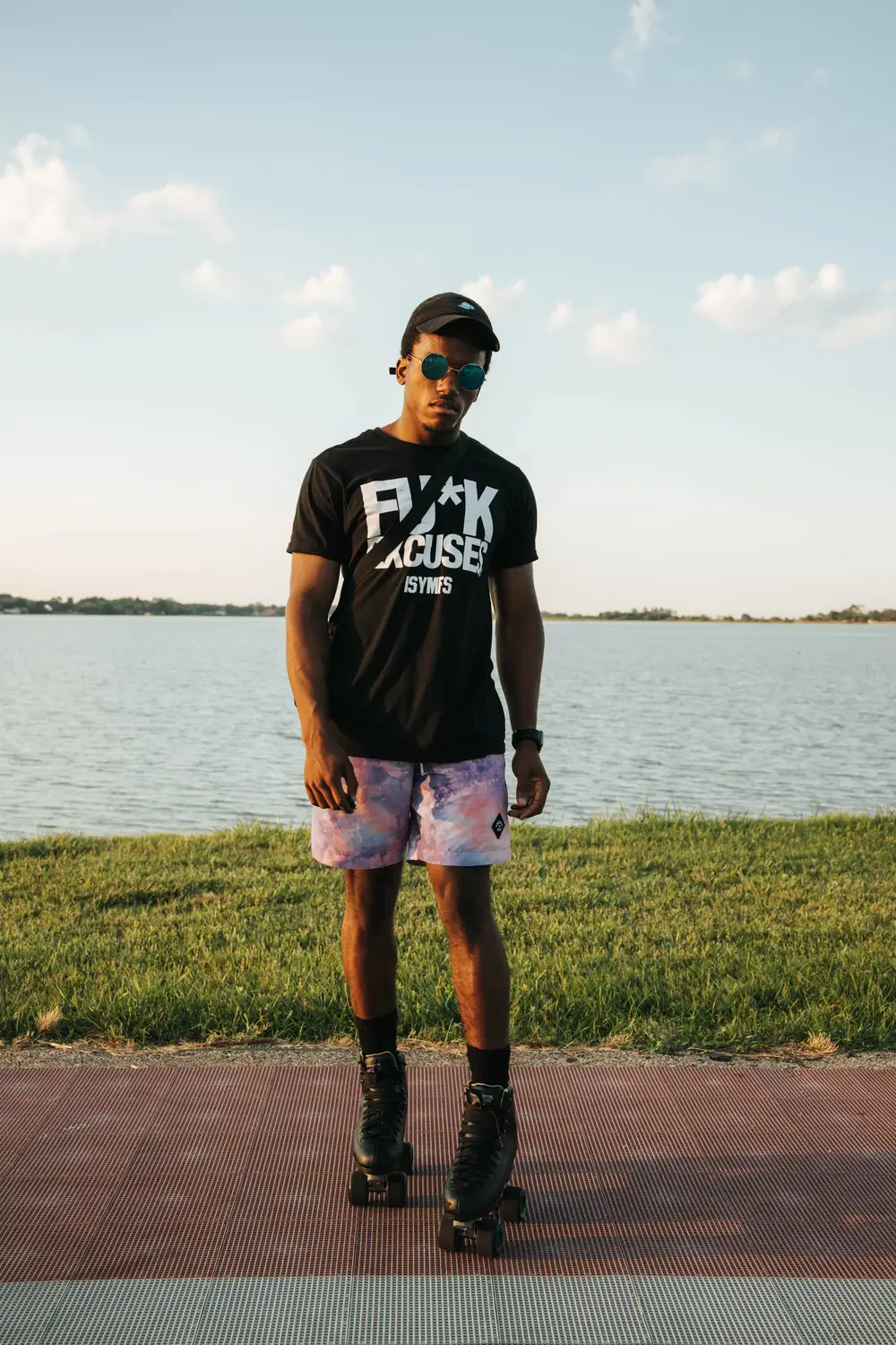 Young black man with a rollerskater by the river